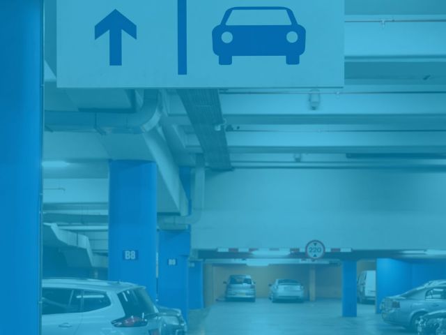 Estacionamento com uma placa sinalizando a saída para os carros